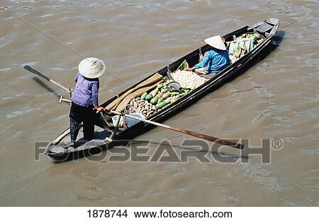 Woman Carrying Produce On A Boat Along The Mekong River View Large Photo Image Picture - Woman Carrying Produce On A Boat Along The Mekong River. Fotosearch
