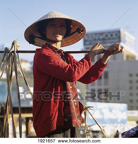 Stock Photo - Woman Carrying Shoulder Baskets, Dalat. Fotosearch