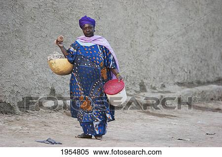 Stock Photography - Woman carrying water in Djenne, Mali. Fotosearch