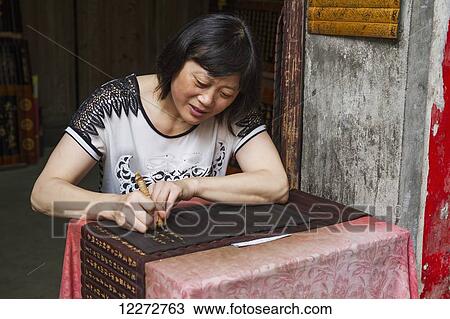 Woman carving inscriptions on wooden panels, Xidi, Anhui, China View Large Photo Image Stock Image - Woman carving inscriptions on wooden panels, Xidi, Anhui, China. Fotosearch