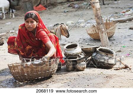 Stock Photo - Woman Cleaning The Dishes, Patna, Bihar, India. Fotosearch
