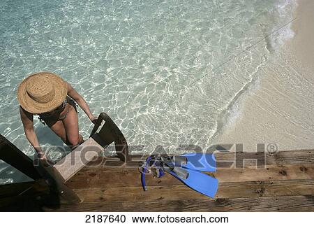 Woman climbing ladder at water's edge with snorkelling gear, Coco Palm Dhuni Kolhu Island; Maldives View Large Photo Image Stock Image - Woman climbing ladder at water's edge with snorkelling gear, Coco Palm Dhuni Kolhu Island; Maldives. Fotosearch