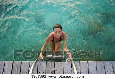 Woman Climbing Pier Ladder After Ocean Swim. View Large Photo Image Stock Image - Woman Climbing Pier Ladder After Ocean Swim.. Fotosearch