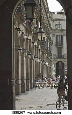 Woman Cycling Under Archway Near Cafes In Placa Reial Square View Large Photo Image Stock Photo - Woman Cycling Under Archway Near Cafes In Placa Reial Square. Fotosearch