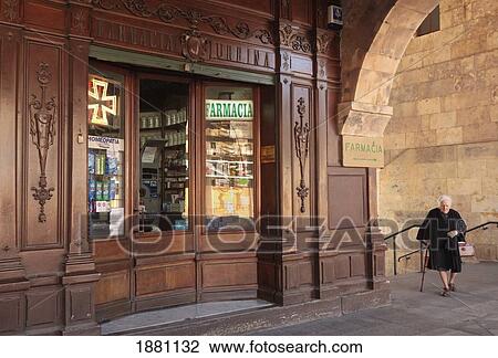 Woman Dressed In Black Walking By Wooden Fronted Chemist Shop In The Plaza Mayor; Salamanca, Salamanca Province, Spain View Large Photo Image Stock Image - Woman Dressed In Black Walking By Wooden Fronted Chemist Shop In The Plaza Mayor; Salamanca, Salamanca Province, Spain. Fotosearch