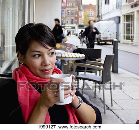 Woman Drinking Coffee At A Table On An Outdoor Patio; Cambridge England View Large Photo Image Stock Photo - Woman Drinking Coffee At A Table On An Outdoor Patio; Cambridge England. Fotosearch
