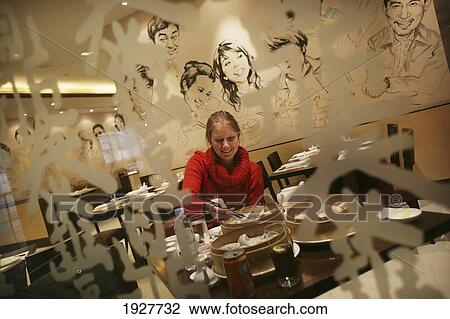 Stock Image - Woman Eating Dumplings With Chopsticks At Din Tai Fung Dumpling House, Xintiandi (Xintiandi), Shanghai, China. Fotosearch