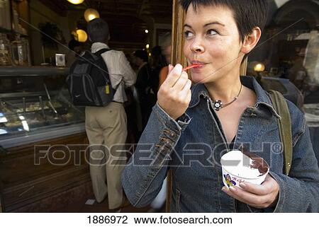 Woman Eating Ice Cream Outside A Gelaterie View Large Photo Image Stock Image - Woman Eating Ice Cream Outside A Gelaterie. Fotosearch