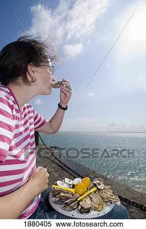Woman Eating Oysters Beside The Sea In Cancale View Large Photo Image Stock Photography - Woman Eating Oysters Beside The Sea In Cancale. Fotosearch
