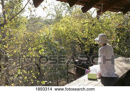 Woman Enjoying View From Baghvan Wilderness Lodge View Large Photo Image Picture - Woman Enjoying View From Baghvan Wilderness Lodge. Fotosearch