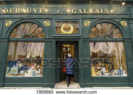 Stock Image - Woman Entering Debauve & Gallais Chocolate Shop, St Germaine, Paris, France. Fotosearch