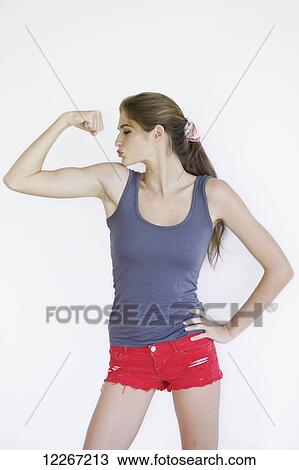 Woman flexing her muscle; Kauai, Hawaii, United States of America View Large Photo Image Stock Image - Woman flexing her muscle; Kauai, Hawaii, United States of America. Fotosearch