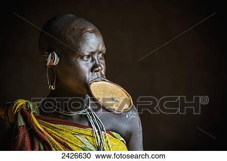 Woman from the Suri (Surma) tribe with traditional clay lip plate, Omo region, Southwest Ethiopia; Kibish, Ethiopia View Large Photo Image Stock Image - Woman from the Suri (Surma) tribe with traditional clay lip plate, Omo region, Southwest Ethiopia; Kibish, Ethiopia. Fotosearch