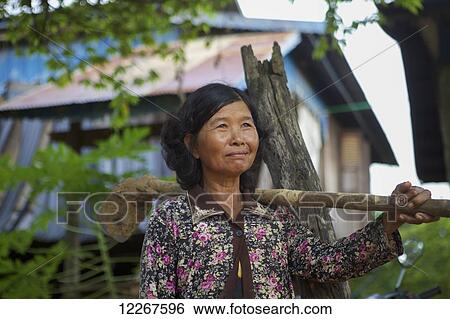 Stock Photograph - Woman going to the fields; Battambang, Cambodia. Fotosearch