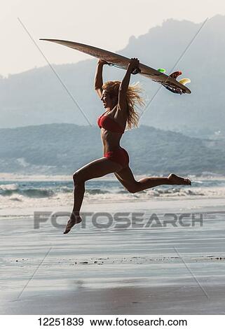 Stock Photo - Woman having fun at the beach; Bolonia, Tarifa, Costa de la Luz, Andalusia, Spain. Fotosearch