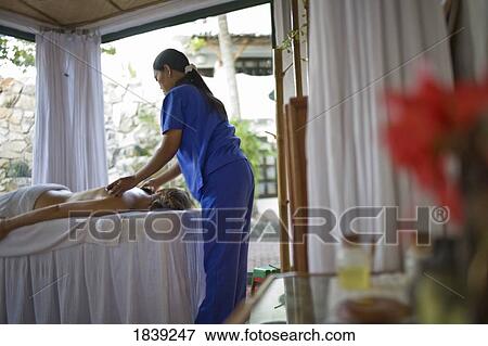 Woman Having Massage In Atlantis Beach Resort; Puerto Gallera, Mindoro Island, Philippines View Large Photo Image Stock Photo - Woman Having Massage In Atlantis Beach Resort; Puerto Gallera, Mindoro Island, Philippines. Fotosearch