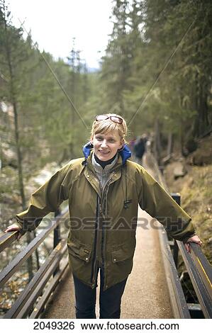 Stock Photograph - Woman Hiking, Johnston Canyon Creek, Banff National Park, Alberta. Fotosearch