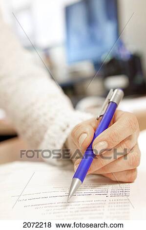 Woman Holding A Pencil Over A Document In An Office View Large Photo Image Stock Photo - Woman Holding A Pencil Over A Document In An Office. Fotosearch