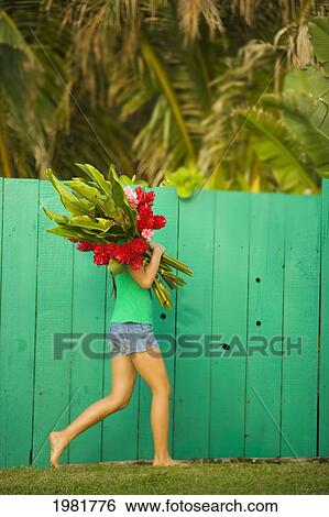 Stock Photograph - Woman holding red and pink ginger flowers. Fotosearch