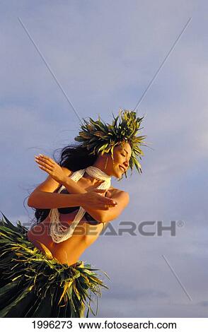 Stock Image - Woman Hula With Arms Crossed Angle View, Ti Leaf Skirt And Haku, Shell Lei. Fotosearch