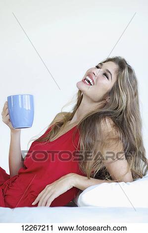 Woman in a red dress with a cup of coffee; Kauai, Hawaii, United States of America View Large Photo Image Stock Image - Woman in a red dress with a cup of coffee; Kauai, Hawaii, United States of America. Fotosearch