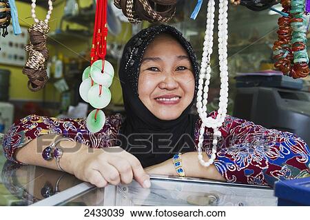 Stock Photo - Woman in a souvenir shop, Pangkalan Bun, Central Kalimantan, Borneo, Indonesia. Fotosearch