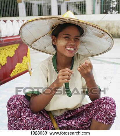 Stock Image - Woman In Conical Hat Miling. Fotosearch