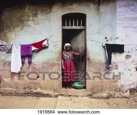 Woman In Front Of The House; Democratic Republic Of Sao Tome And Principe View Large Photo Image Picture - Woman In Front Of The House; Democratic Republic Of Sao Tome And Principe. Fotosearch