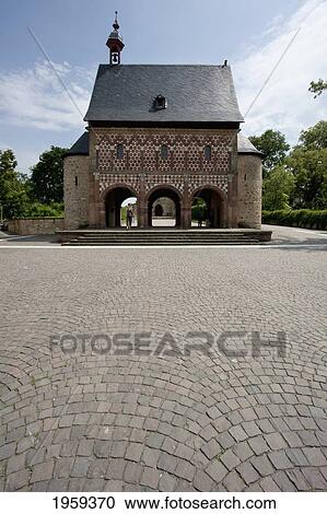 Stock Image - Woman In Front Of The Konigshalle Or Torhalle (King's Hall Or Gatehouse) To The Abbey And Altenmunster Of Lorsch In Lorsch, Germany. Fotosearch
