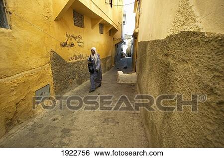 Stock Photograph - Woman In Narrow Street In Moulay Idriss, Morocco. Fotosearch