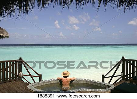 Woman In Pool Looking Out Onto The Ocean. View Large Photo Image Stock Image - Woman In Pool Looking Out Onto The Ocean.. Fotosearch