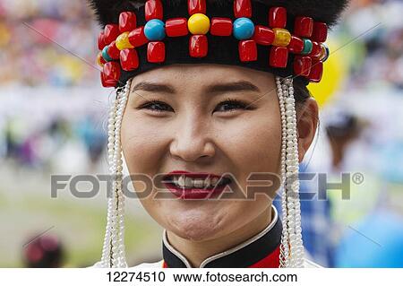 Stock Image - Woman in traditional Buryat dress at the 2014 Naadam Mongolian National Festival celebration by the National Sports Stadium, Ulaanbaatar (Ulan Bator), Mongolia. Fotosearch