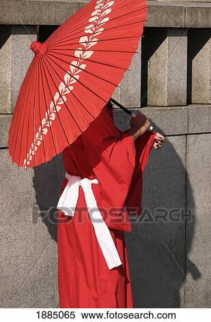 Stock Photography - Woman In Traditional Dress Holding A Parasol. Fotosearch