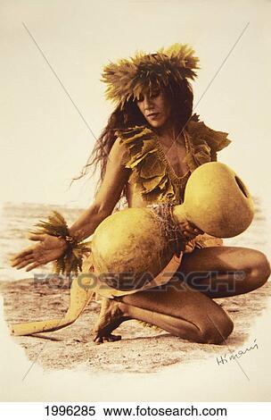 Stock Photography - Woman Kahiko Hula On Beach With Ipu (Gourd) Fern Haku And Wrist Haku. Fotosearch