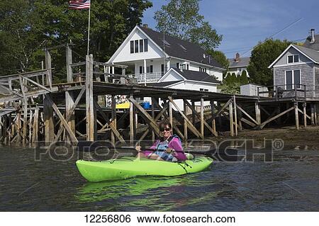 Stock Photograph - Woman kayaking in John's Bay; New Harbor, Maine, United States of America. Fotosearch