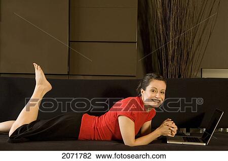 Woman Laying On A Couch Smiling With A Laptop, Toronto, Ontario View Large Photo Image Stock Image - Woman Laying On A Couch Smiling With A Laptop, Toronto, Ontario. Fotosearch