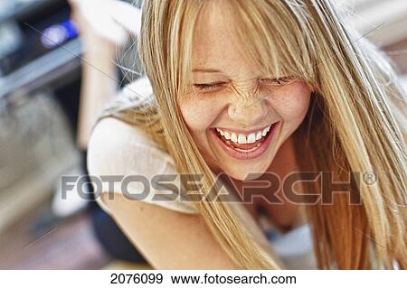 Stock Photo - Woman Laying On Ground Laughing. Fotosearch
