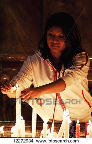 Woman lighting candles at the Catedral de la Inmaculada Concepci? n, the New Cathedral, Cuenca, Azuay, Ecuador View Large Photo Image Picture - Woman lighting candles at the Catedral de la Inmaculada Concepci? n, the New Cathedral, Cuenca, Azuay, Ecuador. Fotosearch