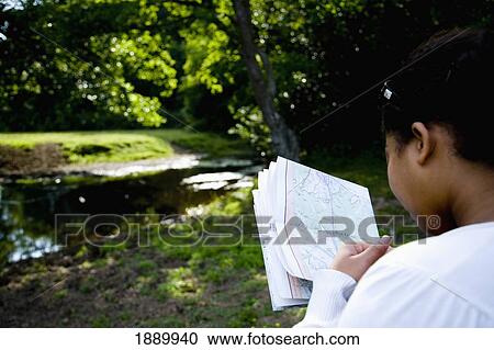 Woman Looking At Map In Forest View Large Photo Image Stock Image - Woman Looking At Map In Forest. Fotosearch
