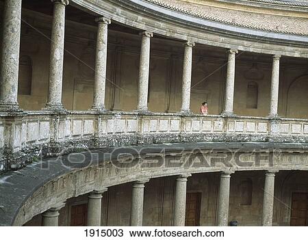 Stock Image - Woman Looking Into The Old Bullring. Fotosearch