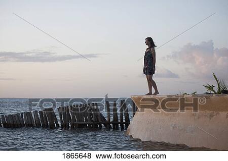 Stock Photo - Woman Looking Out At The Water, Manda Bay Resort, Kenya, Africa. Fotosearch