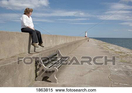 Stock Photography - Woman Looking Out At The Water. Fotosearch
