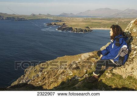 Woman looking out to Blasket Islands from Clogher Head; Dingle, County Kerry, Ireland, UK View Large Photo Image Stock Photo - Woman looking out to Blasket Islands from Clogher Head; Dingle, County Kerry, Ireland, UK. Fotosearch