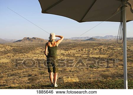 Woman Looking Over Grassland, Umbrella In Foreground View Large Photo Image Stock Photograph - Woman Looking Over Grassland, Umbrella In Foreground. Fotosearch