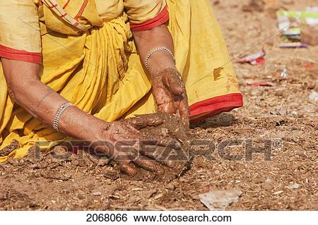 Stock Photograph - Woman Making Cow Dung Patties, Bodhgaya, Bihar, India. Fotosearch