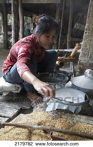 Stock Image - Woman making spring roll pastry Battambang Cambodia. Fotosearch
