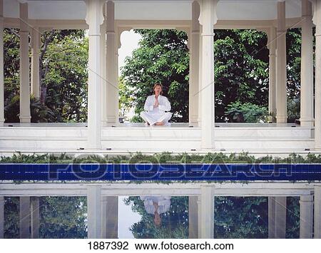 Stock Image - Woman Meditating At Ananda Spa In The Himalayas.. Fotosearch