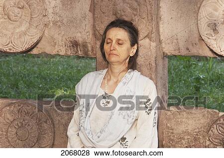 Stock Photo - Woman Meditating, Mahabodi Temple, Bodhgaya, Bihar, India. Fotosearch