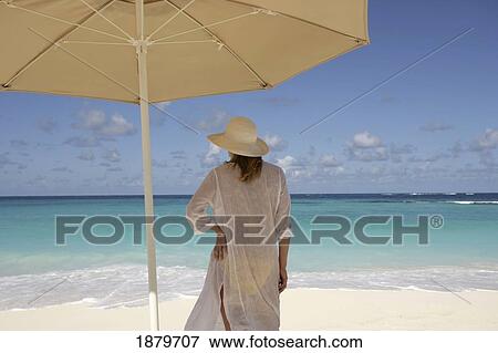Woman On A Tropical Beach Under An Umbrella View Large Photo Image Stock Photo - Woman On A Tropical Beach Under An Umbrella. Fotosearch