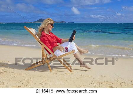 Woman on beach uses electronic tablet. View Large Photo Image Stock Photography - Woman on beach uses electronic tablet.. Fotosearch